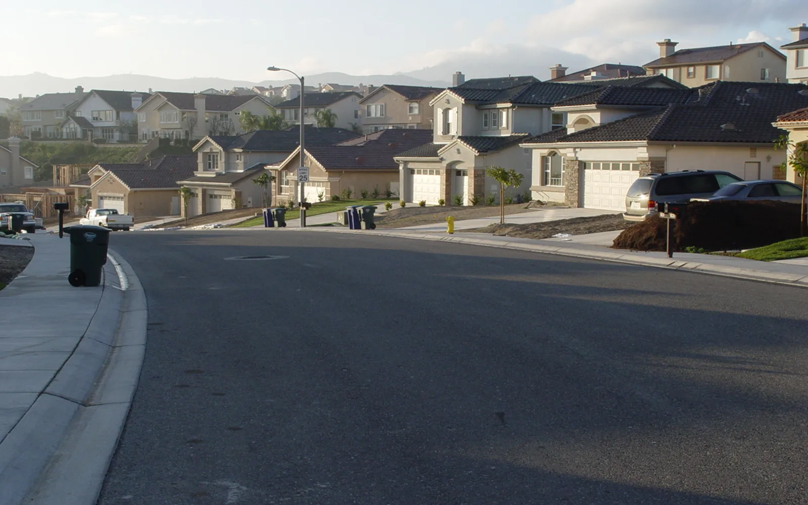 A typical suburban residential street in California, lined with houses and trees